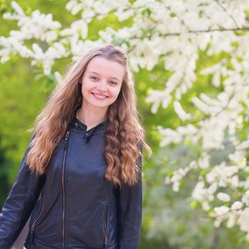 Beautiful young girl in a park on a spring day