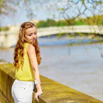 Beautiful young girl walking in Paris on a sunny summer or spring day