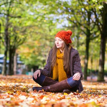 Happy young girl in park on a fall day