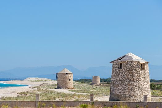 Ancient windmills on Agios Ioannis beach, Lefkada, Greece