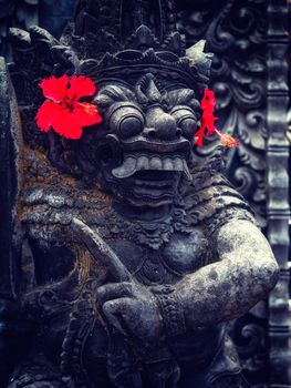 Ancient Balinese statue at the temple in Bali Indonesia