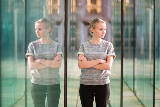 Young beautiful business woman in modern glass interior