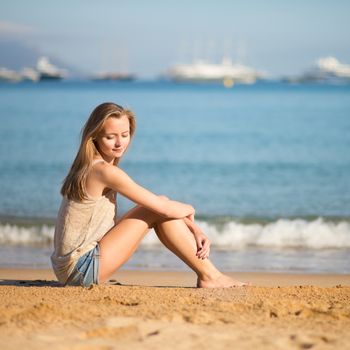 Beautiful young woman relaxing on the beach