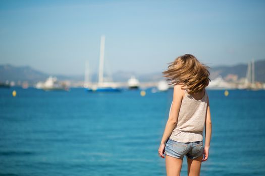 Beautiful young girl on the beach in Cannes, France