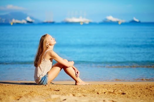 Beautiful young girl enjoying her vacation by the sea 
