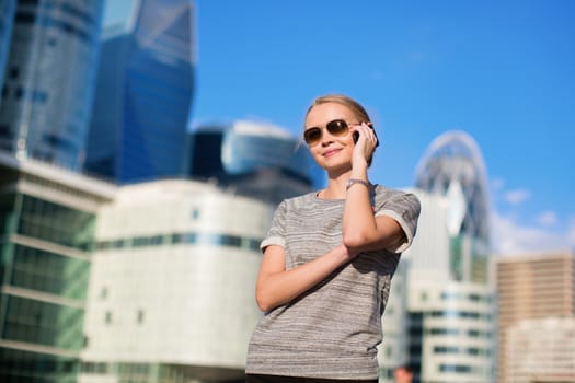 Young beautiful business woman speaking on the phone outdoors