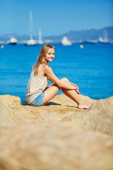 Beautiful young girl enjoying her vacation by the sea 