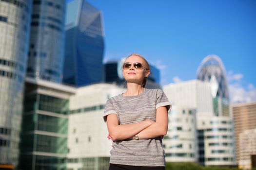 Young confident woman in business district of Paris