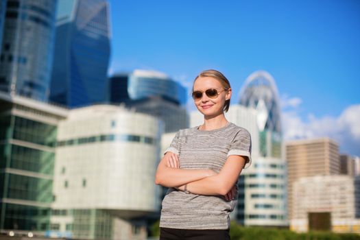 Young confident woman in business district of Paris