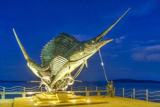 The Sword Fish Sculpture adorning the beach at sunrise  in Ao Nang Krabi Thailand