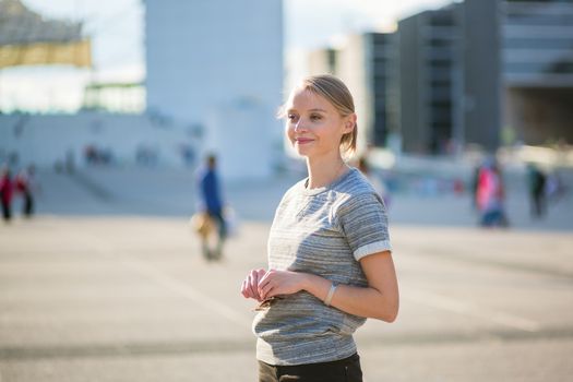 Young beautiful confident woman in business district of Paris 