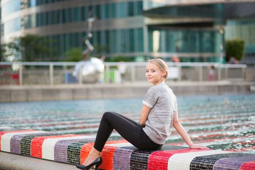 Girl walking at La Defense, business district of Paris