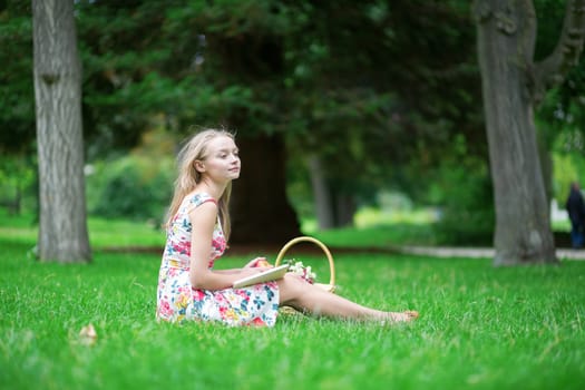 Young beautiful girl having a picnic in the countryside