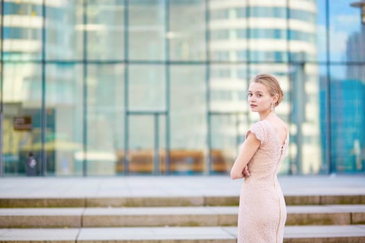 Beautiful young business woman in modern glass office interior