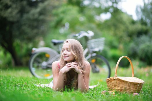 Young beautiful girl having a picnic in the countryside
