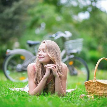 Beautiful young girl spending her time in the countryside