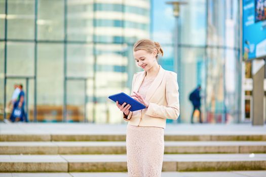 Beautiful young business woman in modern glass office interior
