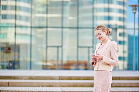 Beautiful young business woman in modern glass office interior