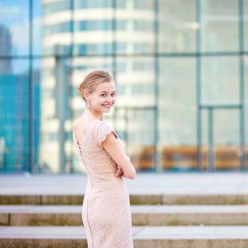 Beautiful young business woman in modern glass office interior
