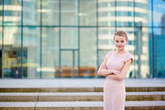 Beautiful young business woman in modern glass office interior