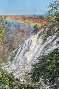 Part of the Ruacana waterfall in the Kunene River. A rainbow is visible