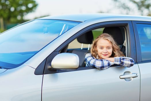 Beautiful young confident woman driving a car