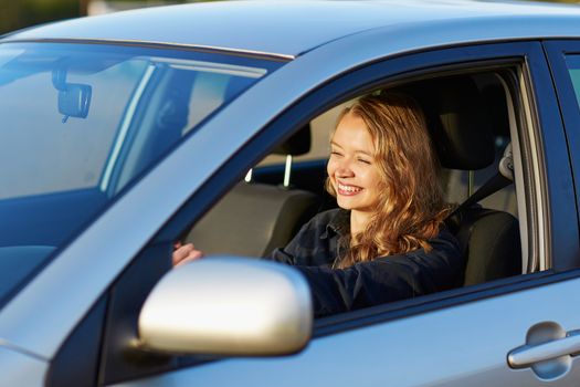 Beautiful and confident young woman driving a car