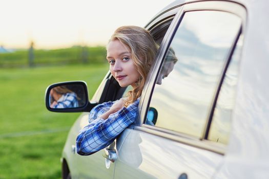 Beautiful young confident woman driving a car