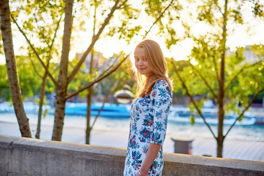 Young beautiful and elegant Parisian woman in blue dress in Paris