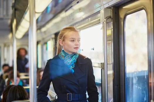Beautiful young woman travelling in a train of Parisian underground