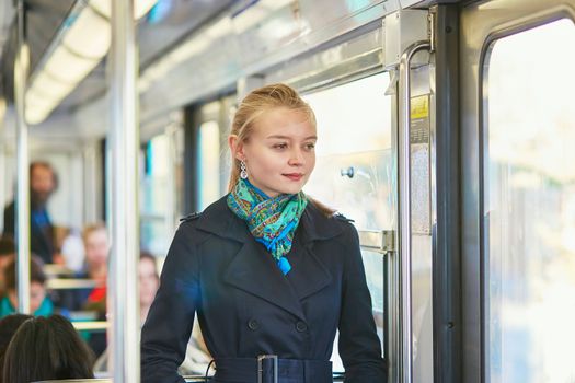 Beautiful young woman travelling in a train of Parisian underground