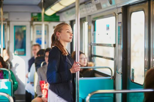Beautiful young woman travelling in a train of Parisian underground