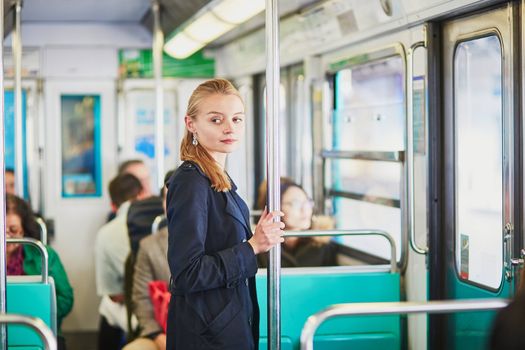 Beautiful young woman travelling in a train of Parisian underground