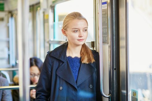 Beautiful young woman travelling in a train of Parisian underground