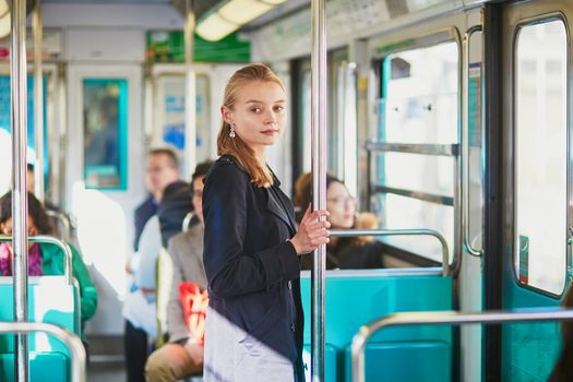 Beautiful young woman travelling in a train of Parisian underground