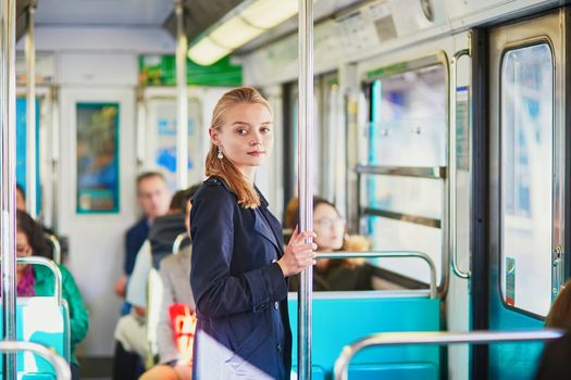 Beautiful young woman travelling in a train of Parisian underground