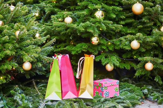 Colorful presents under decorated Christmas tree