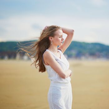 Beautiful young woman enjoying her vacation by ocean or sea. People on sea vacation concept