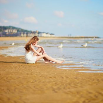Beautiful young woman enjoying her vacation by ocean or sea. People on sea vacation concept