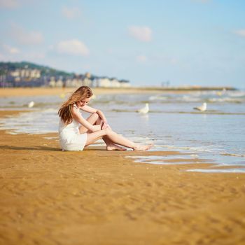 Beautiful young woman enjoying her vacation by ocean or sea. People on sea vacation concept
