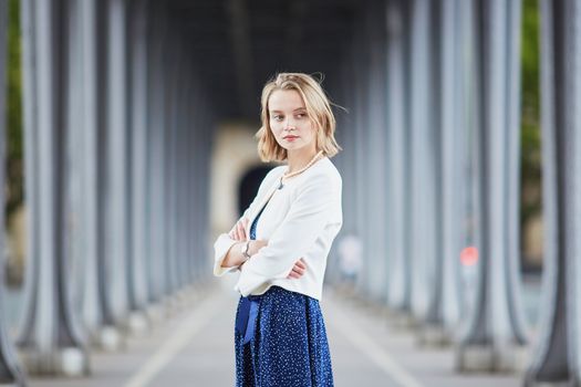 Beautiful young elegant French woman in Paris outdoors