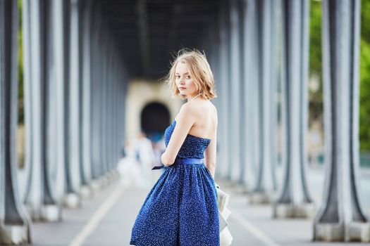 Beautiful young elegant French woman in Paris outdoors