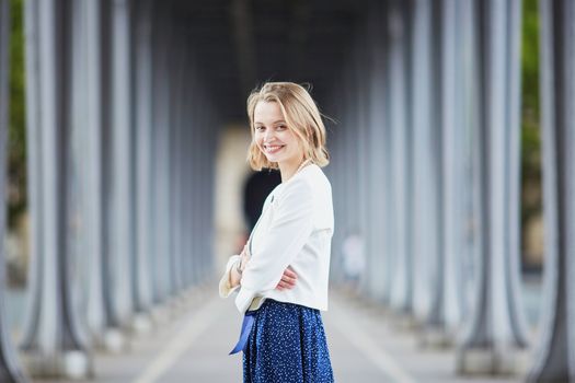 Beautiful young elegant French woman in Paris outdoors