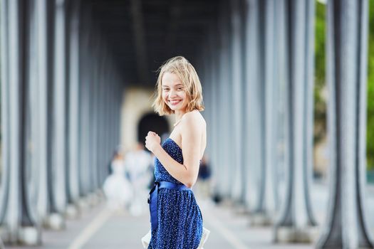 Beautiful young elegant French woman in Paris outdoors