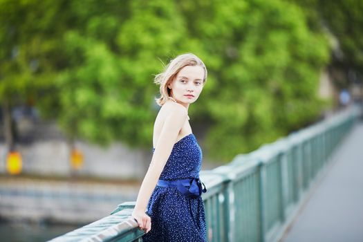 Beautiful young elegant French woman in Paris outdoors
