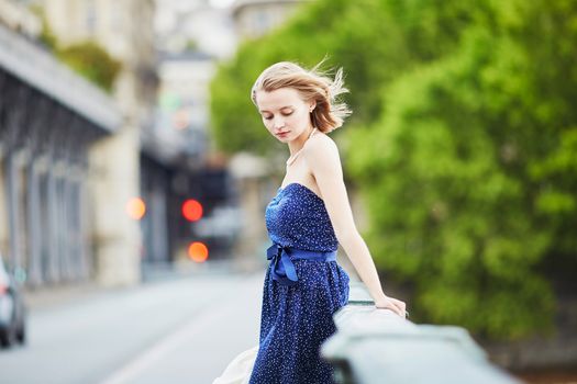 Beautiful young elegant French woman in Paris outdoors