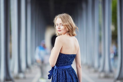 Beautiful young elegant French woman in Paris outdoors