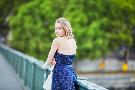 Beautiful young elegant French woman in Paris outdoors