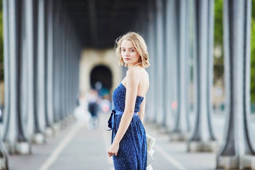 Beautiful young elegant French woman in Paris outdoors