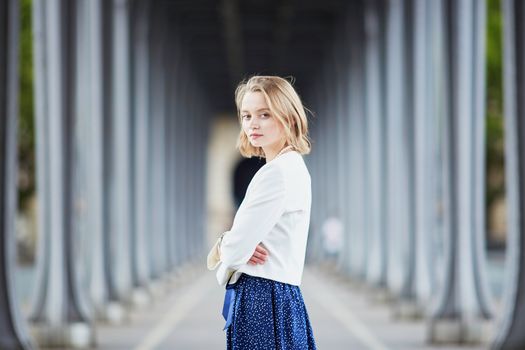 Beautiful young elegant French woman in Paris outdoors